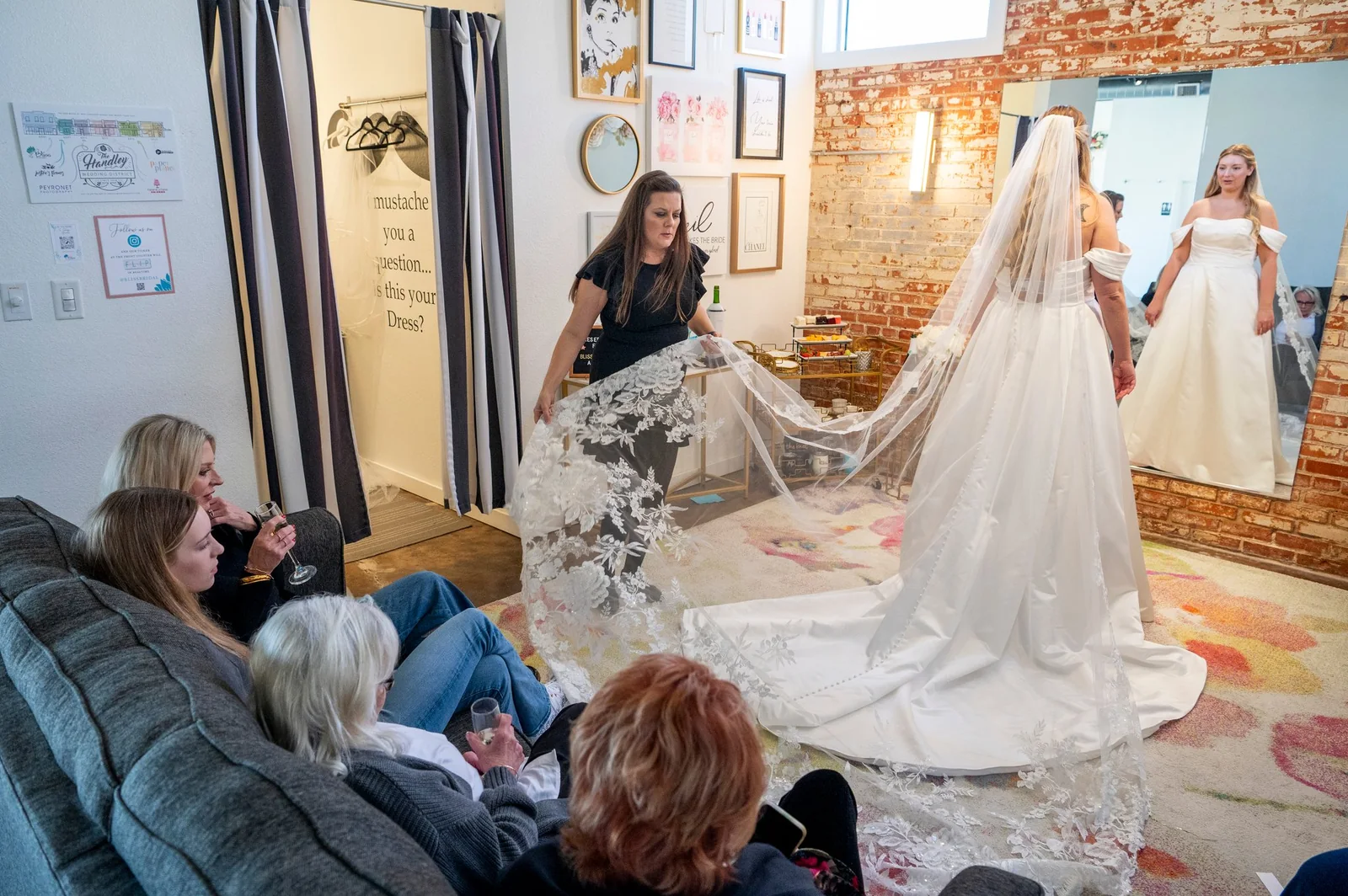 Inside Bliss Bridal Salon — exposed brick, soft light, gowns on the rack